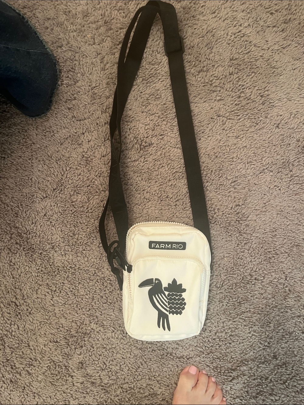 FARM Rio Cream Crossbody Belt Bag with Black Strap and Bird Graphic.